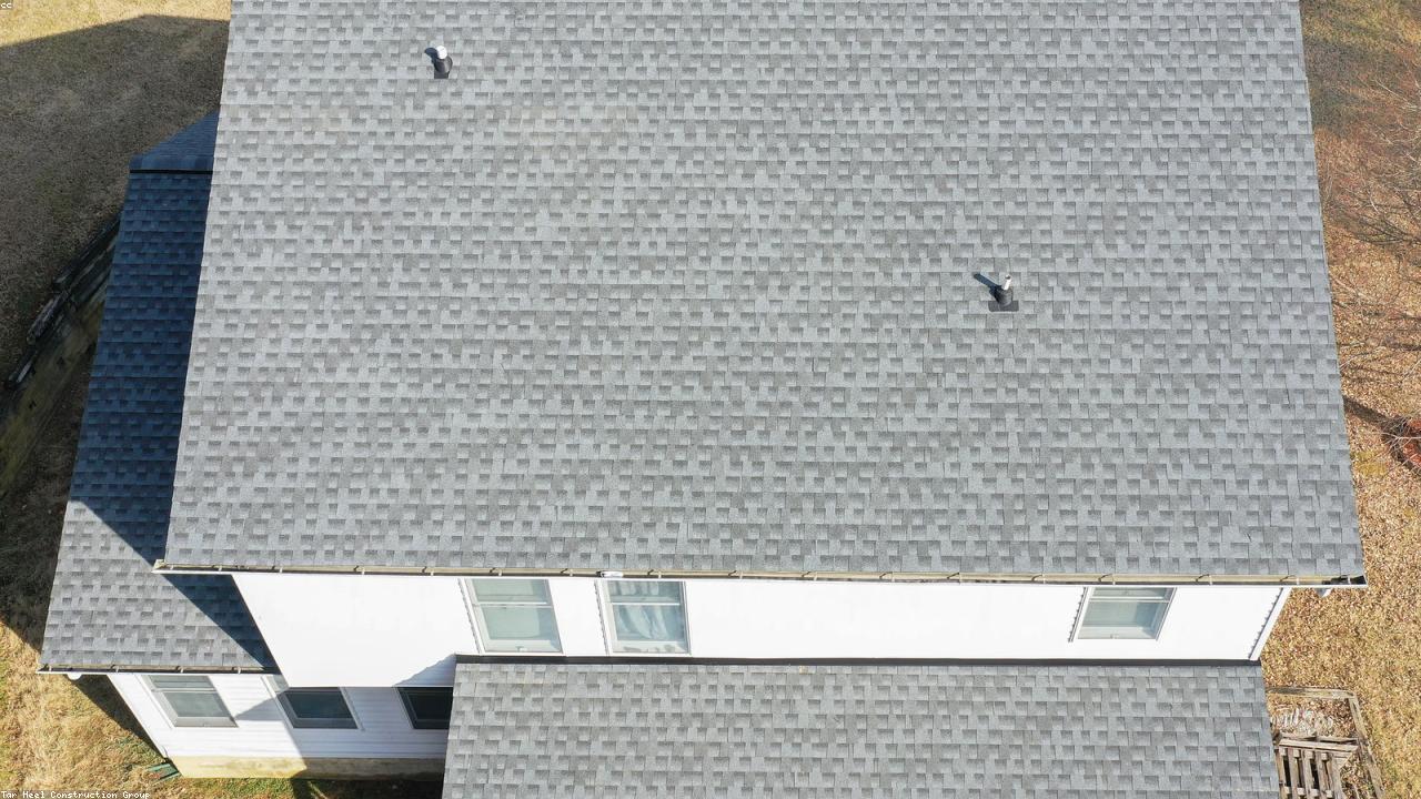 Aerial view of a completed asphalt shingle roof on a split-level home in Lyndhurst, OH